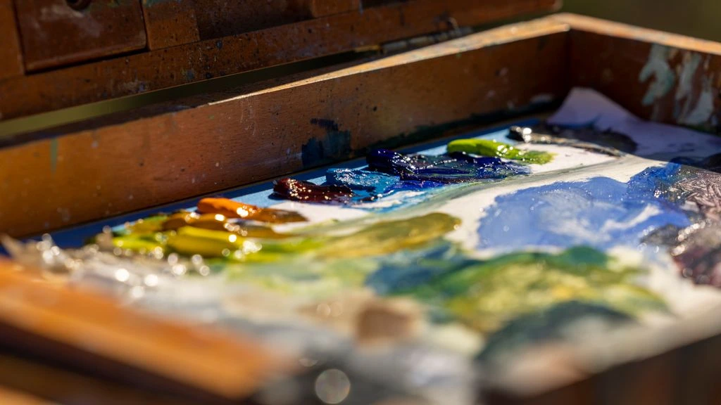 A plein-air oil painting of an Eastern Sierra ridge at late afternoon, mounted on a gallery wall.